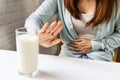 Asian woman gesturing stop or say no to drink milk. Lactose intolerance, food allergy concept. Closeup