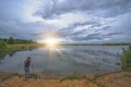 Female girl standing by a pond at sunrise Royalty Free Stock Photo