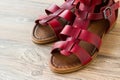 Female gladiator slippers made of genuine leather on wooden surface,half view Royalty Free Stock Photo