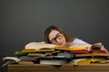 Female in glasses Studying Hard Exam and Sleeping on Books Royalty Free Stock Photo