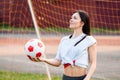 Female goalkeeper ball in his hands, standing at football goal