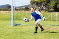 Female goalkeeper about to throw a football