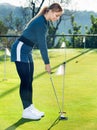 Female golf player getting ready to hit ball Royalty Free Stock Photo