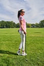 Female golfer with a club staring into the distance Royalty Free Stock Photo