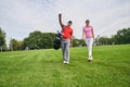 Female golfer and her personal trainer staring into the distance Royalty Free Stock Photo
