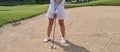 Female golfer hits ball in bunker concept Royalty Free Stock Photo