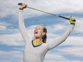 Female Golfer Holding Club Against Sky Royalty Free Stock Photo