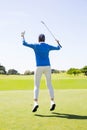 Female golfer leaping and cheering Royalty Free Stock Photo