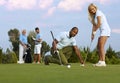 Female golfer learning to putt Royalty Free Stock Photo