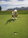 Female Golfer Lining Up A Putt Royalty Free Stock Photo