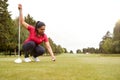 Female Golfer Preparing To Hit Tee Shot Along Fairway With Driver Royalty Free Stock Photo