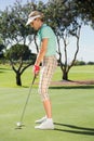 Female golfer putting her ball Royalty Free Stock Photo