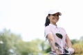 Female golfer smiles and holds bag of golf clubs Royalty Free Stock Photo