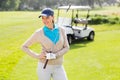 Female golfer smiling with hands on hip Royalty Free Stock Photo