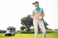 Female golfer smiling and posing Royalty Free Stock Photo