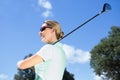 Female golfer standing holding her club smiling Royalty Free Stock Photo