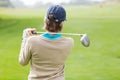 Female golfer taking a shot Royalty Free Stock Photo