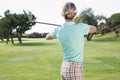 Female golfer taking a shot Royalty Free Stock Photo