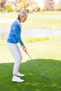 Female golfer taking a shot Royalty Free Stock Photo