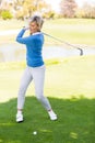 Female golfer taking a shot Royalty Free Stock Photo