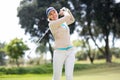 Female golfer taking a shot Royalty Free Stock Photo