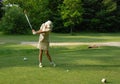 Female golfer tee-off Royalty Free Stock Photo