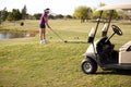 Female golfer about to swing Royalty Free Stock Photo