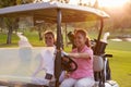 Female Golfers Driving Buggy Along Fairway Of Golf Course Royalty Free Stock Photo