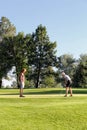 Two women on the putting green at a golf tournament Royalty Free Stock Photo