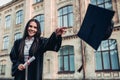 Female graduate near university