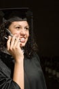 Female graduate using a cellular phone Royalty Free Stock Photo