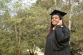 Female graduate using a cellular phone Royalty Free Stock Photo