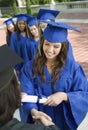 Female Graduates Collecting Certificate From Dean