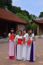 Female graduates posing for their graduation in traditional Vietnamese attire, Ao Dai.