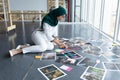 Female graphic designer in hijab checking photographs in office Royalty Free Stock Photo