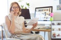 Female graphic designer talking on mobile phone in office Royalty Free Stock Photo