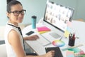 Female graphic designer using graphic tablet at desk in a modern office Royalty Free Stock Photo