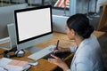 Female graphic designer using graphics tablet at desk Royalty Free Stock Photo