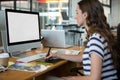 Female graphic designer using graphics tablet at desk Royalty Free Stock Photo