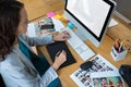 Female graphic designer using graphics tablet at desk Royalty Free Stock Photo