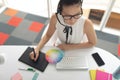 Female graphic designer using graphic tablet at desk in a modern office Royalty Free Stock Photo