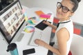 Female graphic designer using graphic tablet at desk in a modern office Royalty Free Stock Photo