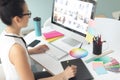 Female graphic designer using graphic tablet at desk in a modern office Royalty Free Stock Photo