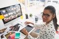 Female graphic designer working on computer at desk Royalty Free Stock Photo