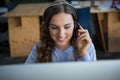 Female graphic designer working over computer at desk Royalty Free Stock Photo