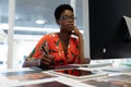 Female graphic designer working on graphic tablet at desk Royalty Free Stock Photo