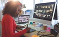 Female graphic designer working on graphic tablet at desk Royalty Free Stock Photo