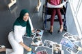 Female graphic designers looking at photographs in office Royalty Free Stock Photo