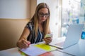 Female graphics designer reading information on mobile phone