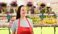 Female greengrocer looking askance Royalty Free Stock Photo